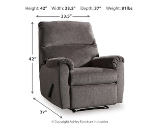 Ashley Nerviano manual recliner with plush fabric and padded armrests, shown in a relaxed seated position.
