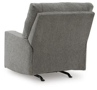 Ashley Newellen manual recliner with plush fabric and padded backrest, shown from the back in a cozy living room setting.