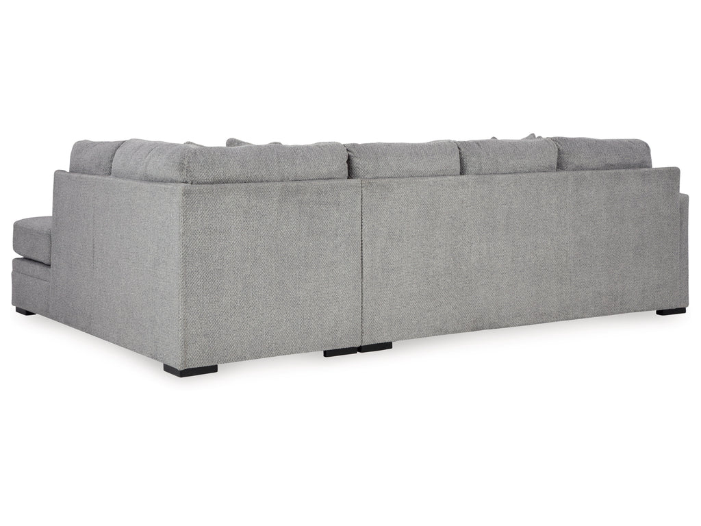 Grey plush U-shaped sectional sofa by Ashley, showing the back view with plush fabric and spacious seating for living room comfort.