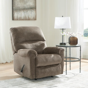 Ashley Stonemeade manual rocker recliner in beige fabric with plush cushioning and a padded back for comfortable sitting.