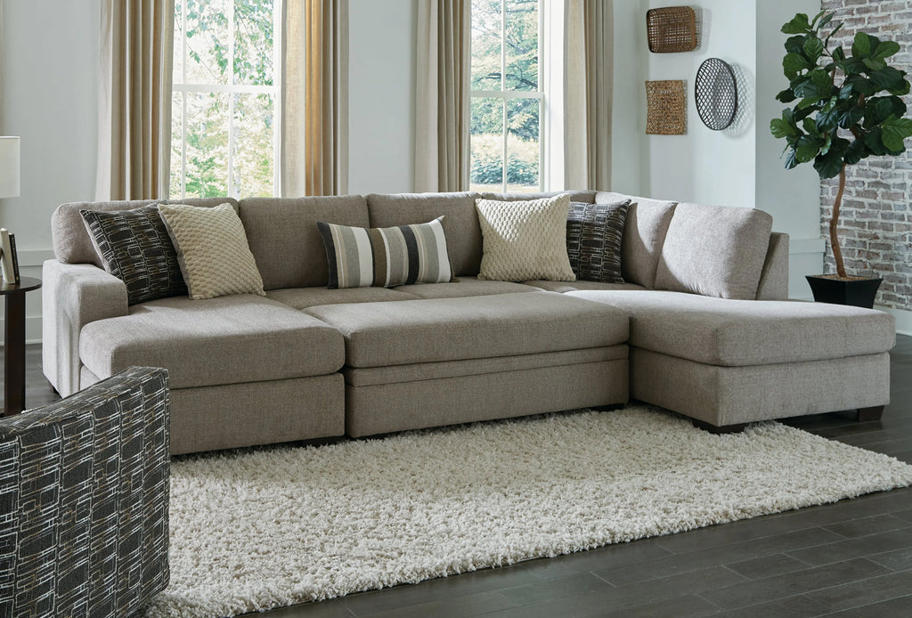 Brown U-shaped sectional sofa by Behold, showing plush cushions and wooden legs in a modern living room setting.