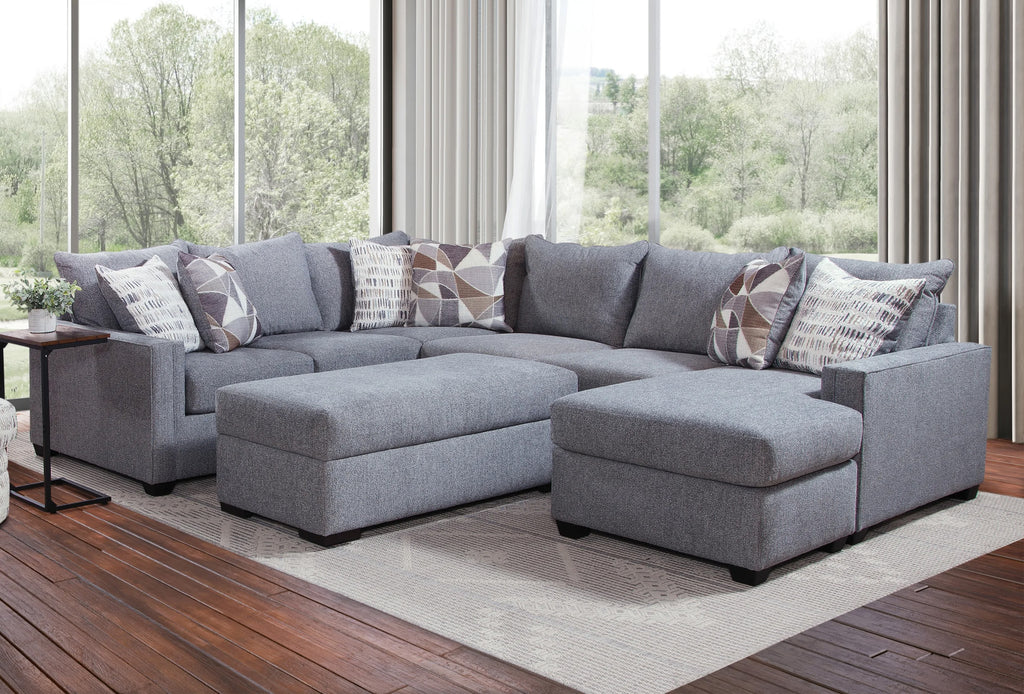 Light grey U-shaped sectional sofa by Ashley, featuring plush cushions and modern design, shown in a stylish living room setting.