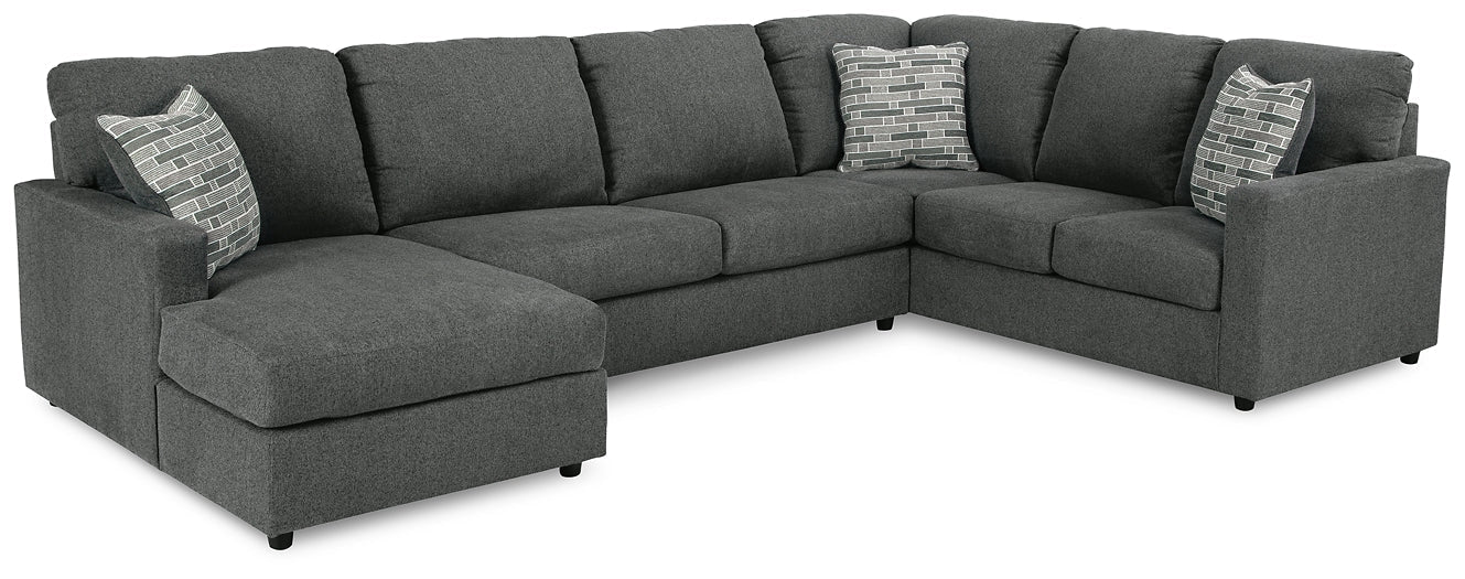 Charcoal grey Ashley U-shaped sectional sofa with plush cushions and modern design, shown in a stylish studio setting.