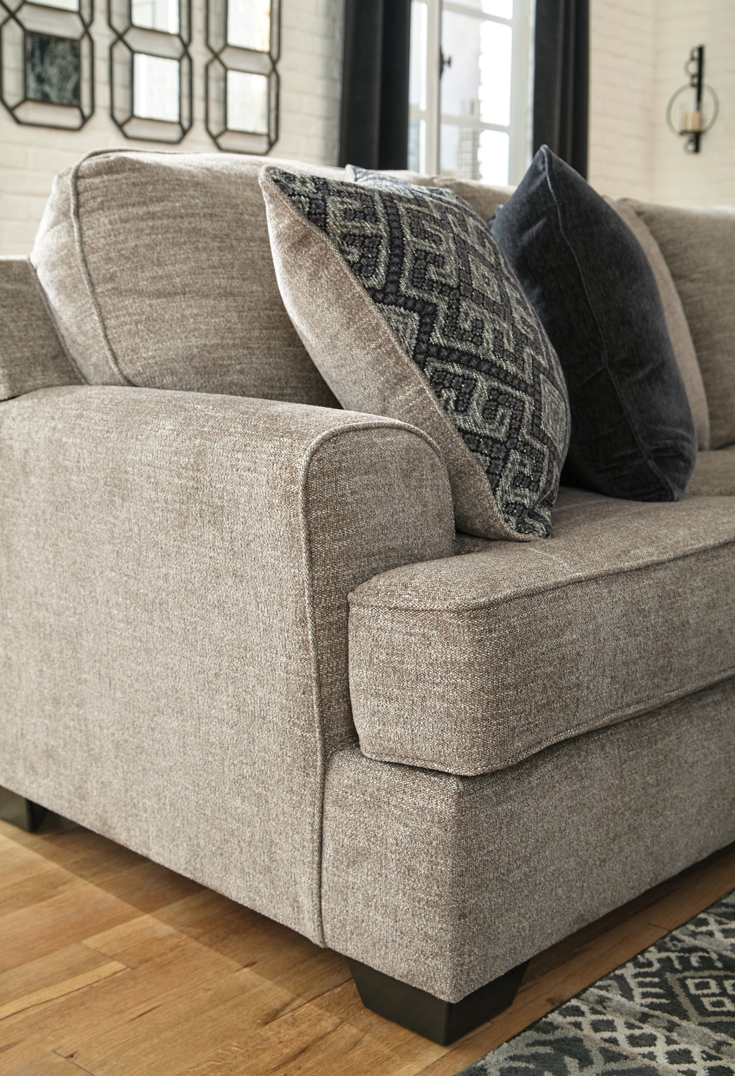 Brown Ashley L-shaped sectional sofa with plush cushions and modern design in a stylish living room setting.