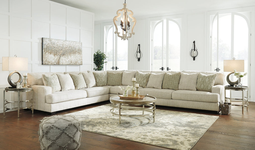 Ivory L-shaped sectional sofa by Ashley, showcasing plush cushions and modern design in a stylish living room setting.