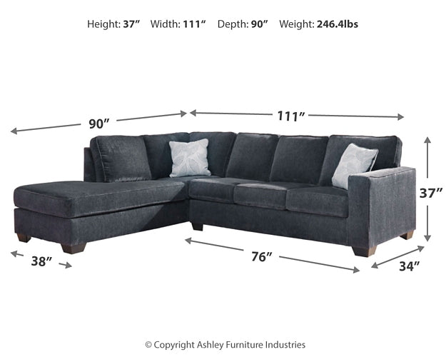 Slate grey Ashley L-shaped sectional sofa in a modern studio setting with plush cushions and a sleek design.