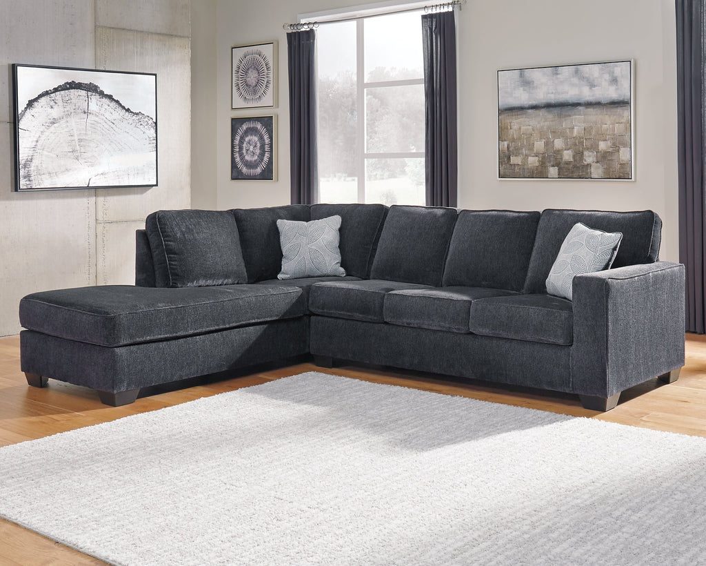 Slate grey Ashley L-shaped sectional sofa in a modern studio setting, showing plush cushions and sleek upholstery.
