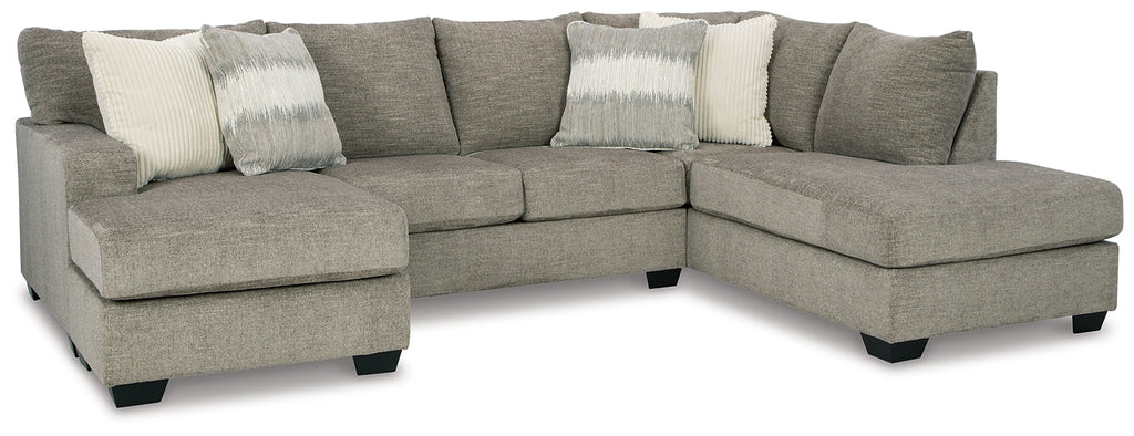 Beige U-shaped sectional sofa by Ashley, showing plush fabric and spacious design in a modern living room setting.