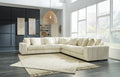 Ivory corduroy L-shaped sectional sofa by Ashley, with plush cushions and modern design, in a stylish studio setting.