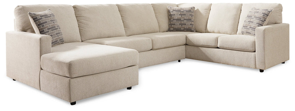 Cream U-shaped sectional sofa by Ashley with plush cushions and modern design, shown in a stylish living room setting.
