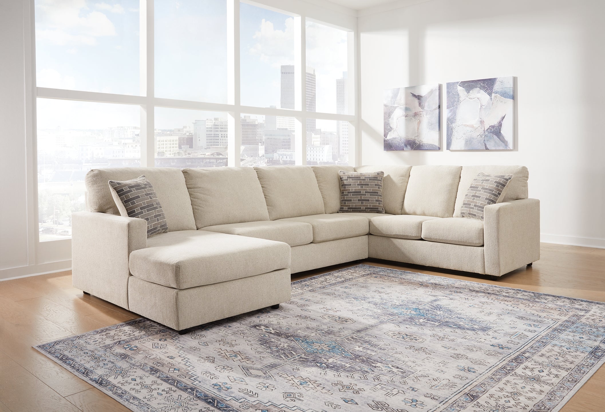Ashley Cream U-shaped sectional sofa with plush cushions in a modern living room setting.