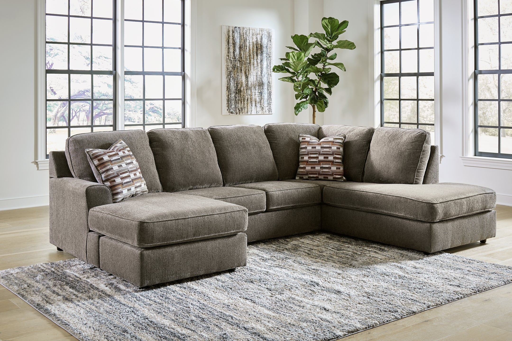 Brown Ashley U-shaped sectional sofa with plush cushions and modern design, shown in a stylish living room setting.