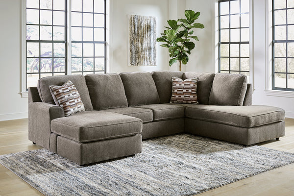 Brown Ashley U-shaped sectional sofa with plush cushions and modern design, shown in a stylish living room setting.