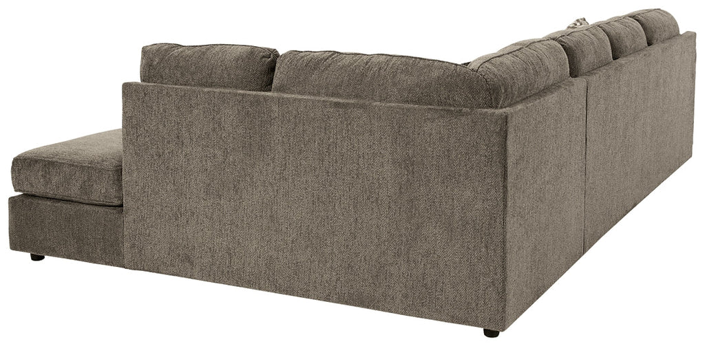 Ashley brown U-shaped sectional sofa with plush cushions and modern design, shown in a stylish studio setting.