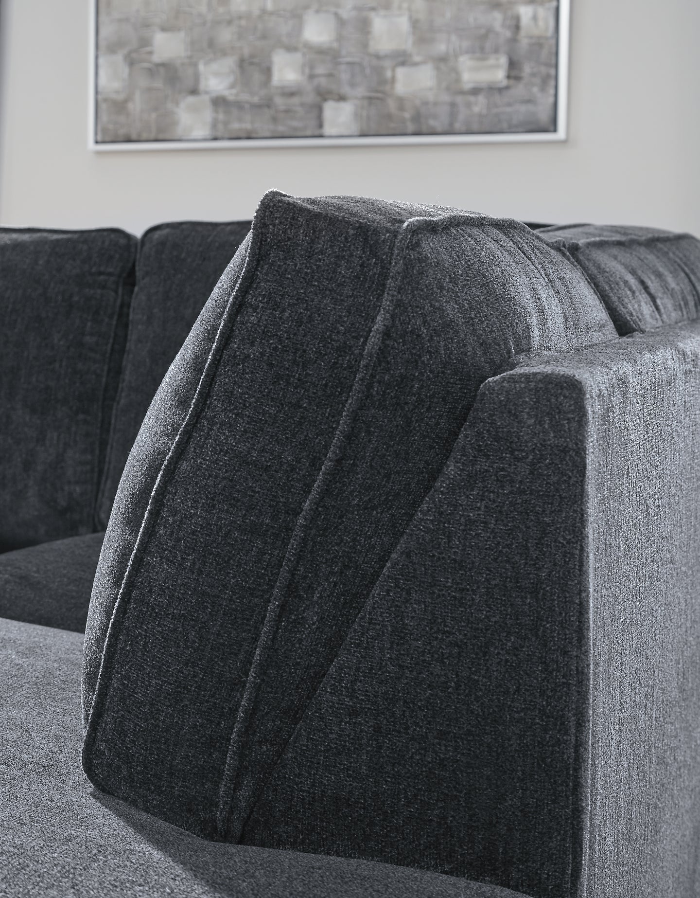 Slate grey Ashley L-shaped sleeper sectional in a modern living room setting with plush cushions and a sleek design.