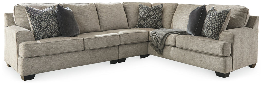 Brown Ashley L-shaped sectional sofa with plush cushions and modern design, shown in a stylish studio setting.