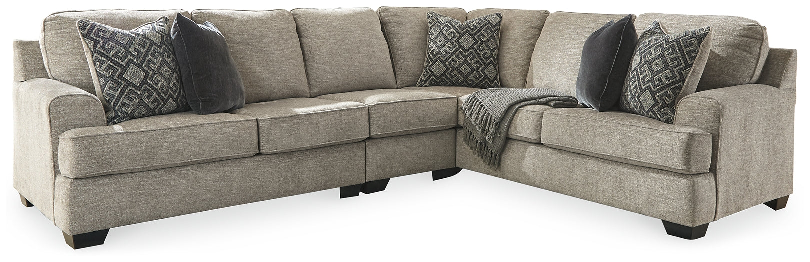 Brown Ashley L-shaped sectional sofa with plush cushions and modern design, shown in a stylish studio setting.