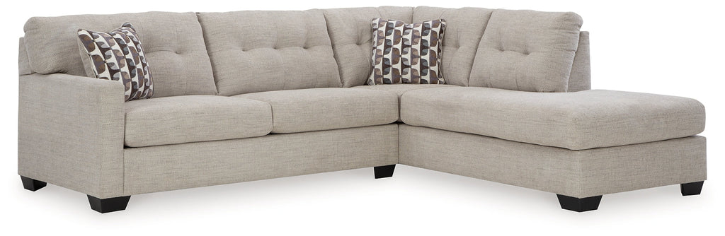 Beige Ashley L-shaped sectional sofa in a modern living room with plush cushions and clean lines.