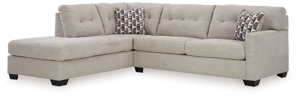 Beige Ashley L-shaped sectional sofa in a modern living room setting with plush cushions and wide armrests.