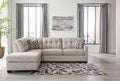 Beige Ashley L-shaped sectional sofa in a modern studio setting, featuring plush cushions and sleek fabric upholstery.