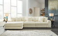 Ivory corduroy sofa chaise by Ashley with plush cushions and a modern design in a studio setting.