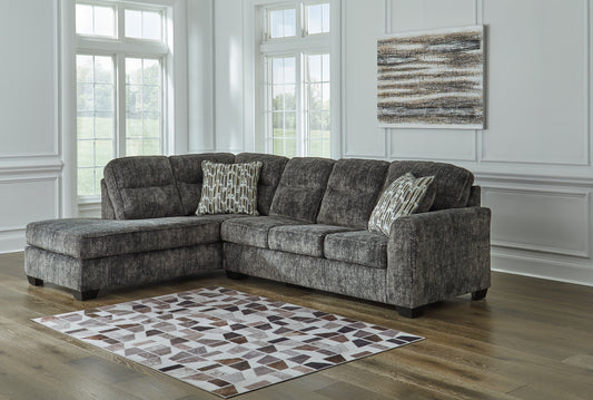 Grey Ashley L-shaped sectional sofa in a modern living room setting with plush cushions and sleek design.