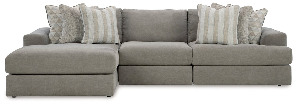 Grey Ashley sofa chaise with plush cushions and modern design, shown in a stylish studio setting.