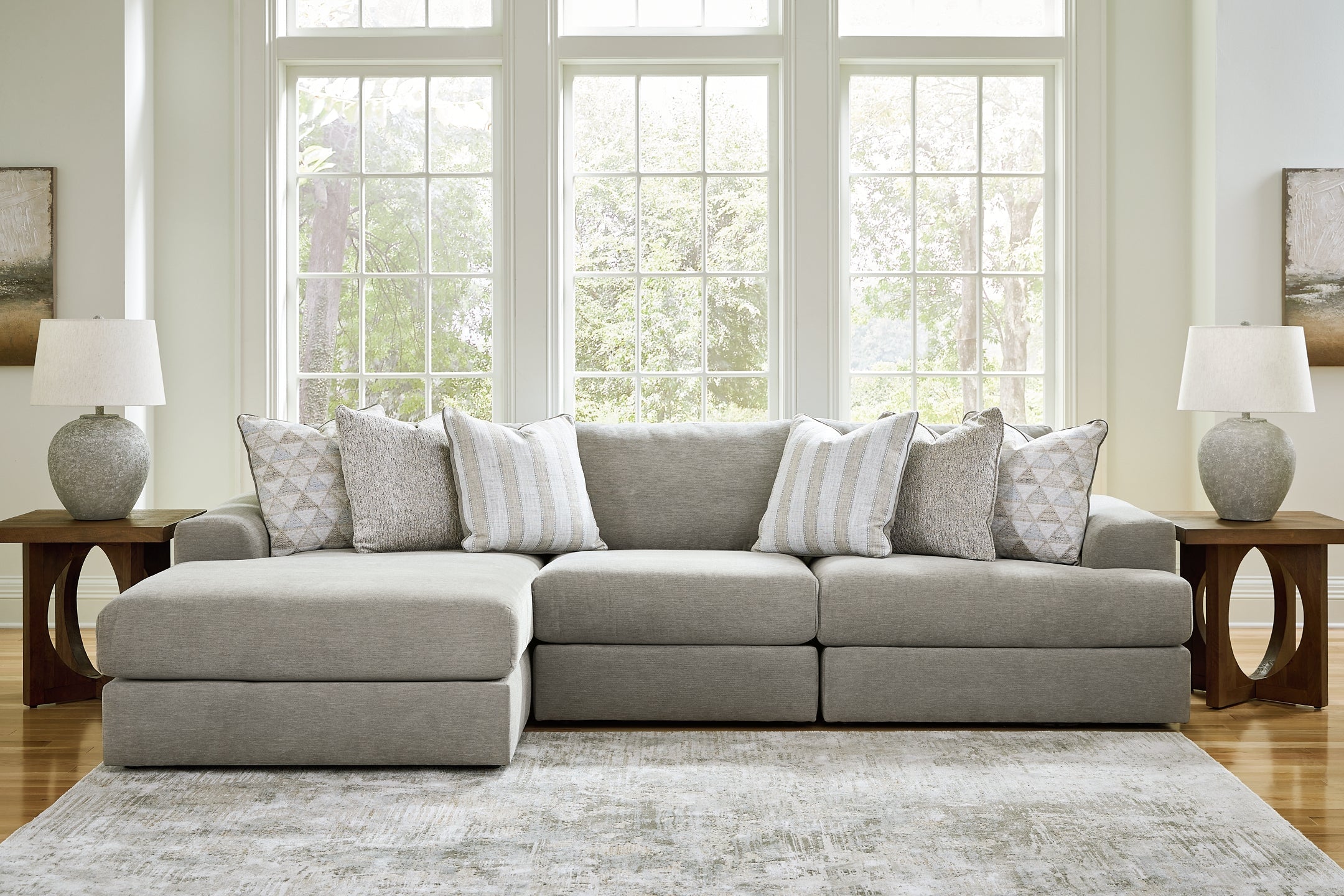 Ashley grey sofa chaise with plush fabric, modern design, and cushioned seating in a stylish living room setting.
