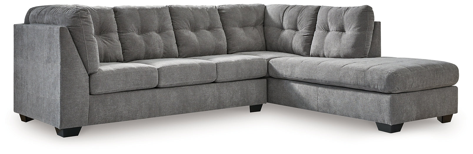 Grey L-shaped sectional sofa by Ashley, featuring plush cushions and modern design, shown in a stylish living room setting.