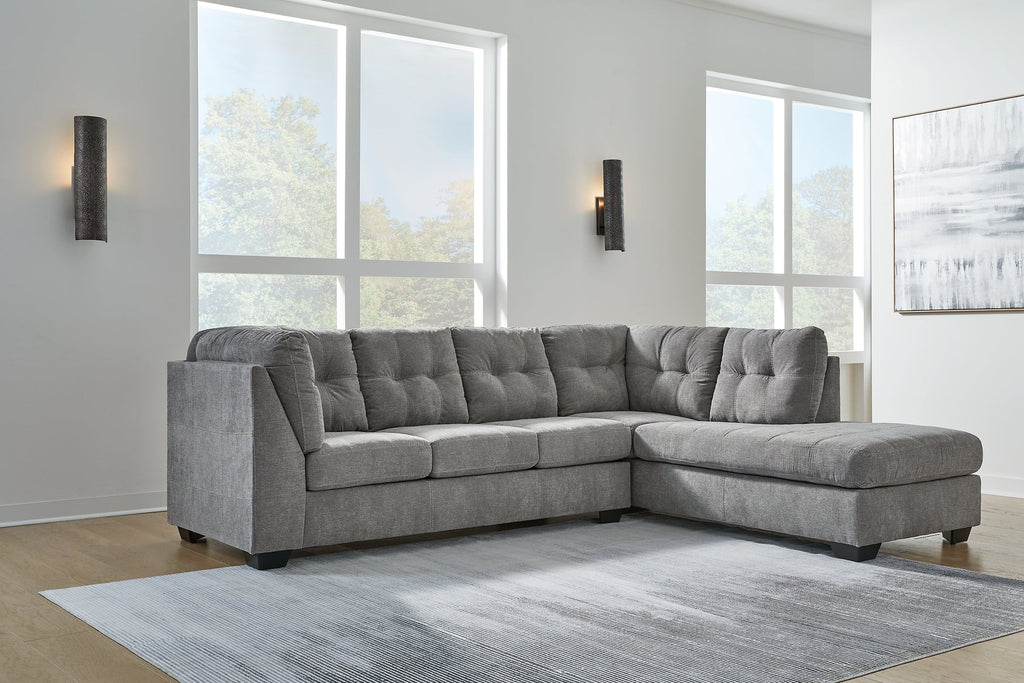 Grey Ashley L-shaped sectional sofa in a modern living room, showcasing plush cushions and a spacious design.