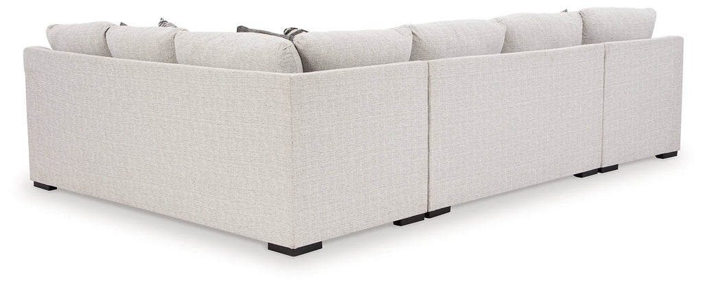 Ashley Off White U-shaped sectional sofa with plush cushions, modern design, and spacious seating in a stylish living room setting.