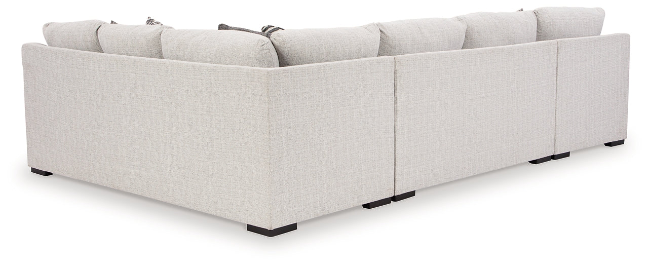 Ashley Off White U-shaped sectional sofa with plush cushions, modern design, and spacious seating in a stylish living room setting.