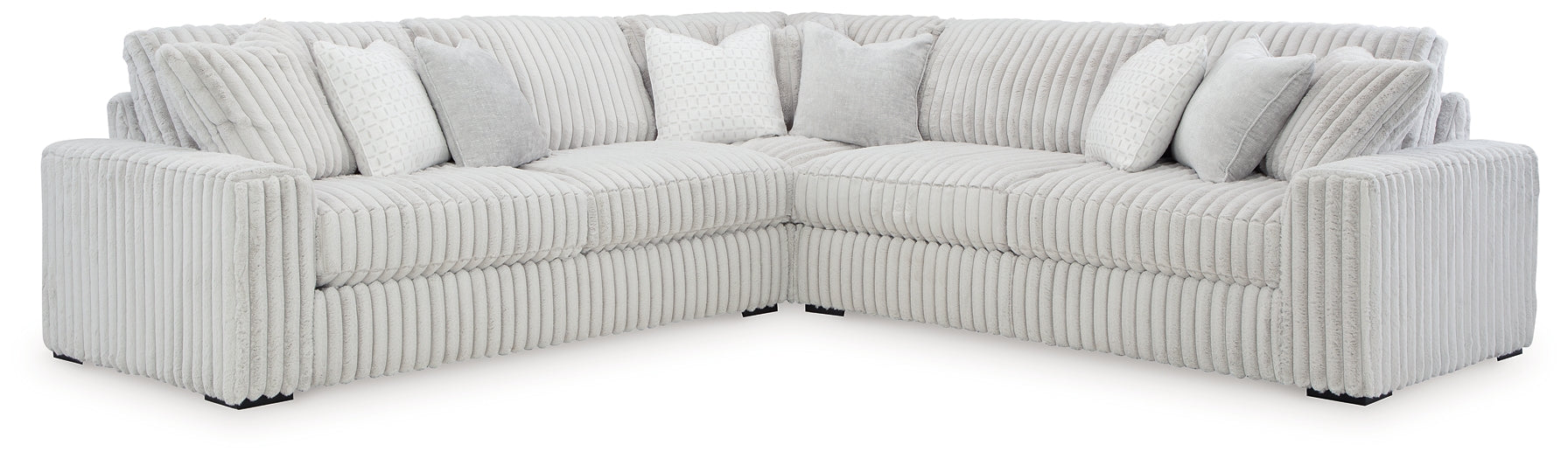Ashley alloy corduroy L-shaped sectional sofa in a modern studio setting, showcasing plush fabric and spacious seating.