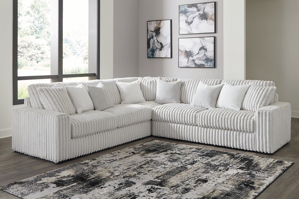 Ashley alloy corduroy L-shaped sectional sofa in a modern home studio setting with plush cushions and contemporary design.