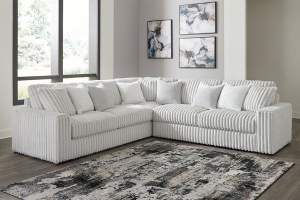 Ashley alloy corduroy L-shaped sectional sofa in a modern home studio setting with plush cushions and contemporary design.