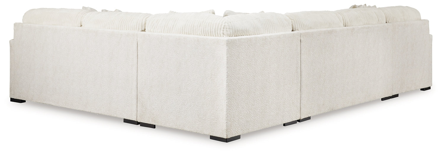 Ivory U-shaped sectional sofa by Ashley in a modern living room setting with plush cushions and contemporary design.