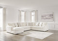 Ivory U-shaped sectional sofa by Ashley with plush cushions and modern design, shown in a stylish living room setting.