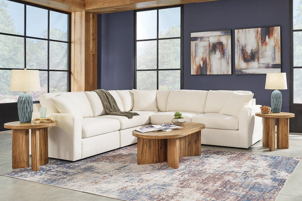 Cream Ashley modular L-shaped sectional sofa in a modern studio setting with plush cushions and sleek design.