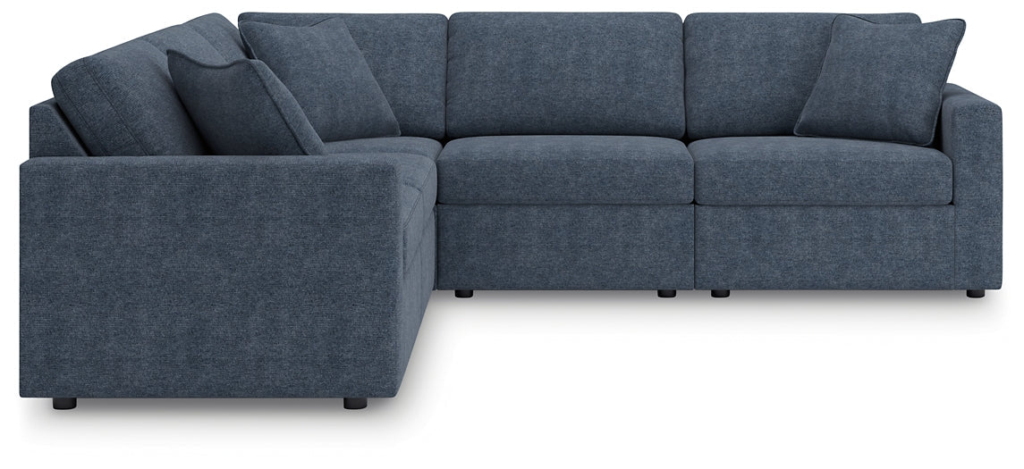 Blue Ashley modular L-shaped sectional sofa with plush cushions and modern design, shown in a stylish living room setting.