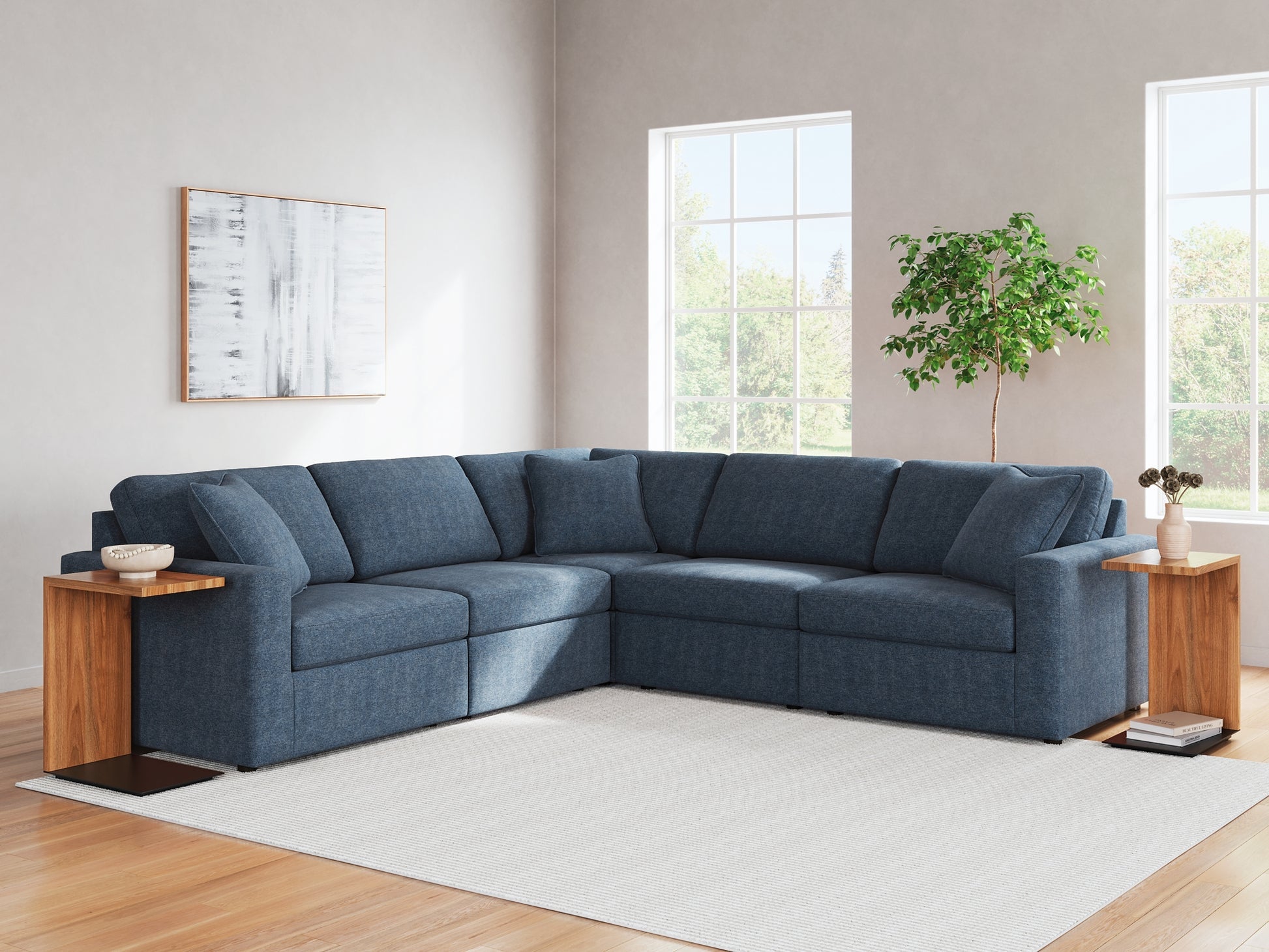 Blue Ashley modular L-shaped sectional sofa with plush cushions in a modern studio setting.