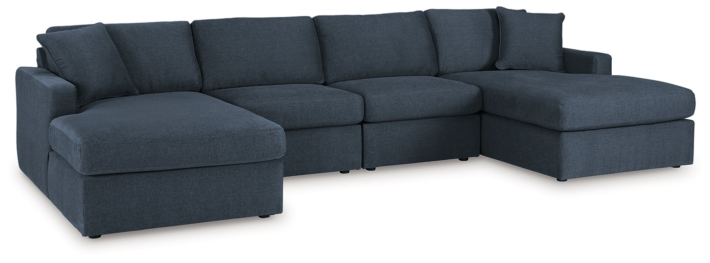 Blue Ashley modular U-shaped sectional sofa in a modern studio setting with plush cushions and sleek design.