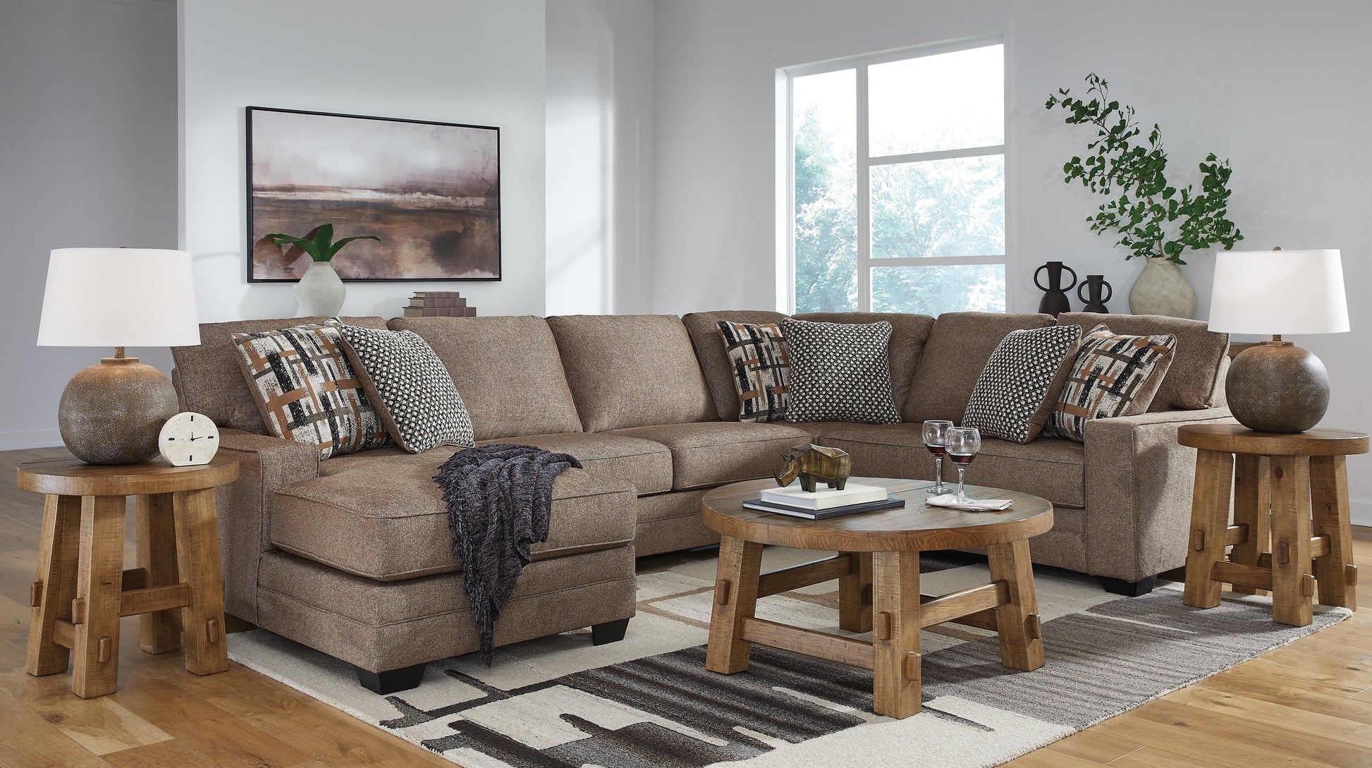 Brown Ashley U-shaped sectional sofa in a stylish living room setting, featuring plush cushions and modern design.