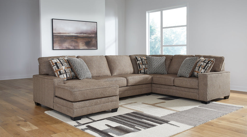 Brown Ashley U-shaped sectional sofa with plush cushions and modern design, shown in a stylish studio setting.