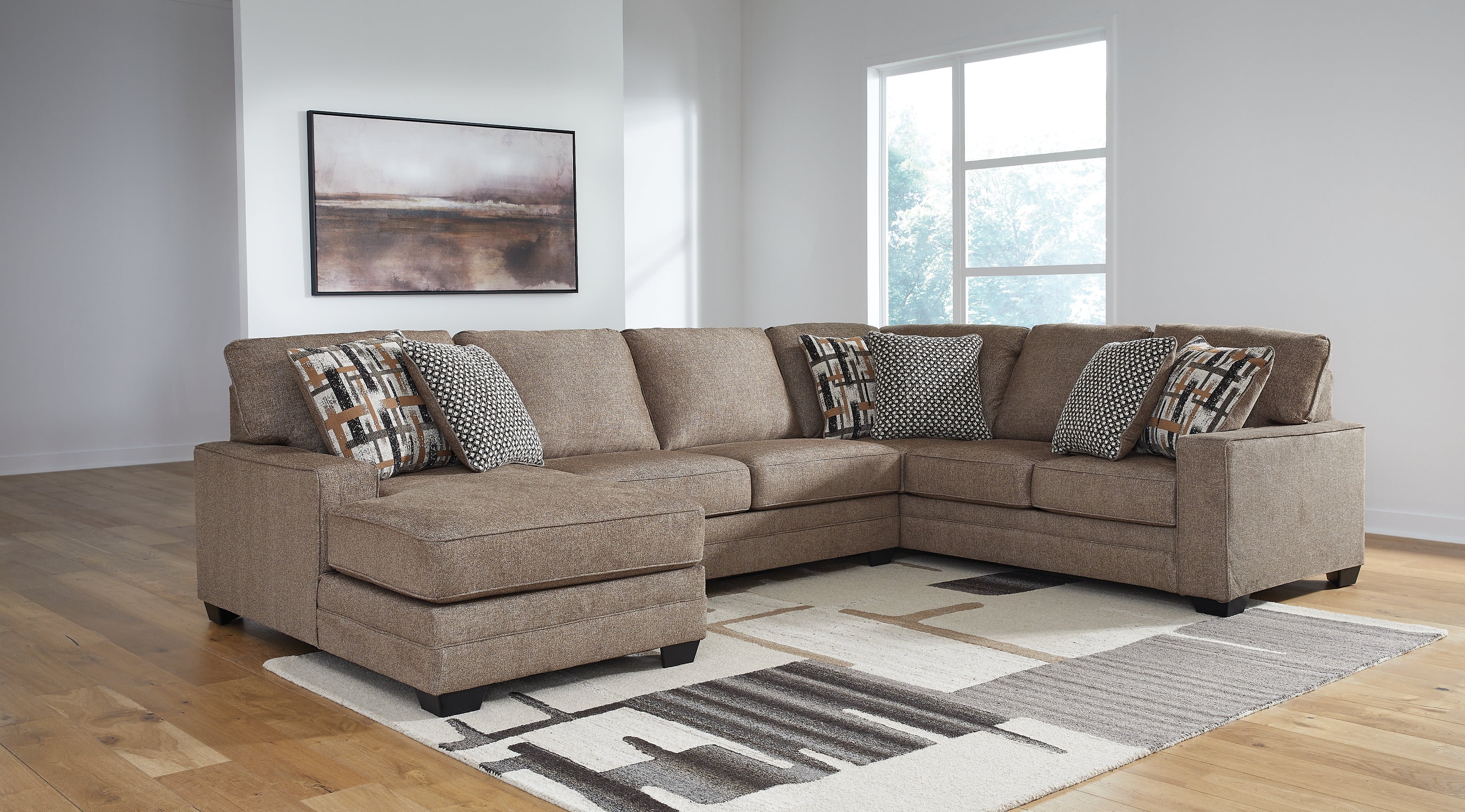 Brown Ashley U-shaped sectional sofa with plush cushions and modern design, shown in a stylish studio setting.