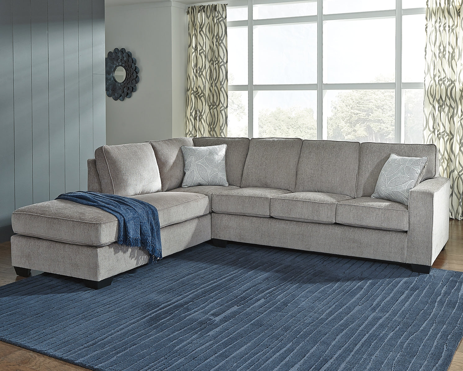 Grey Ashley L-shaped sleeper sectional sofa in a modern living room with plush cushions and clean lines.
