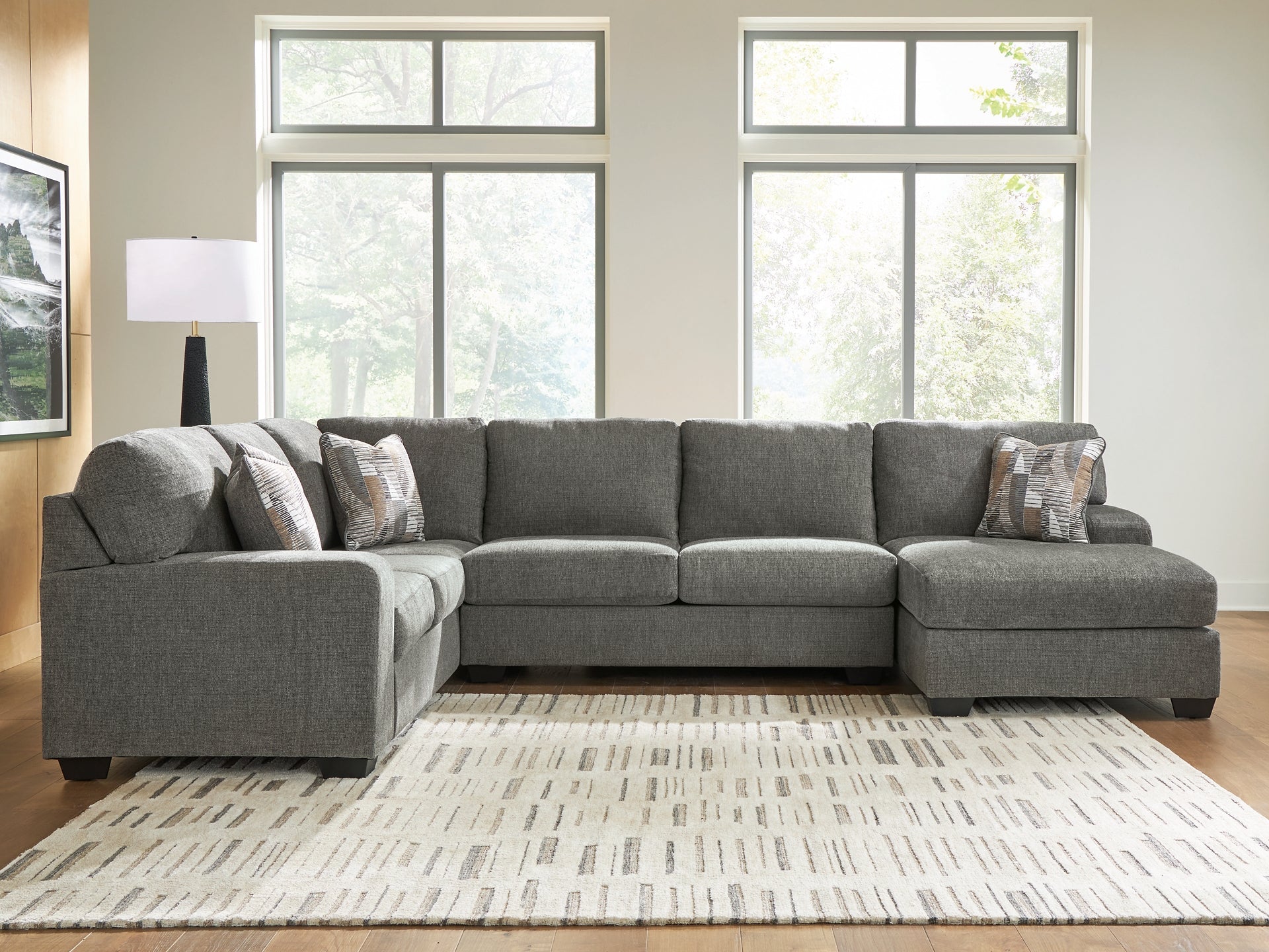 Grey Ashley U-shaped sectional sofa with plush cushions and modern design, shown in a stylish living room setting.