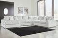 Ivory corduroy U-shaped sectional sofa by Ashley, showcasing plush cushions and modern design in a studio setting.