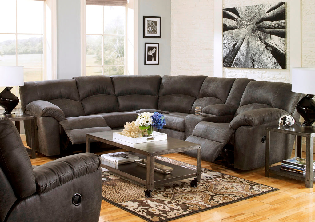 Ashley faux leather reclining sectional in pewter, featuring plush cushions and reclining seats for comfortable living room seating.