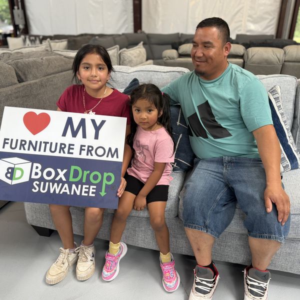 A family with their new sectional at BoxDrop Suwanee
