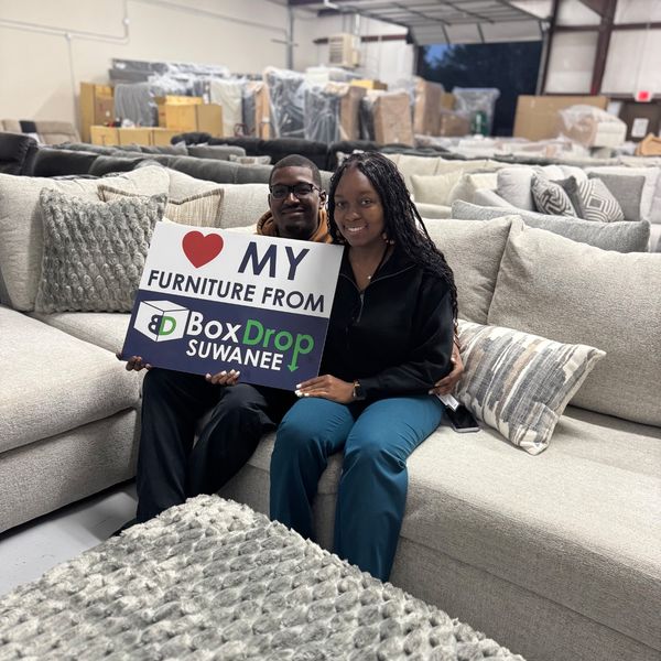 Two customers with their new sofa at BoxDrop Suwanee